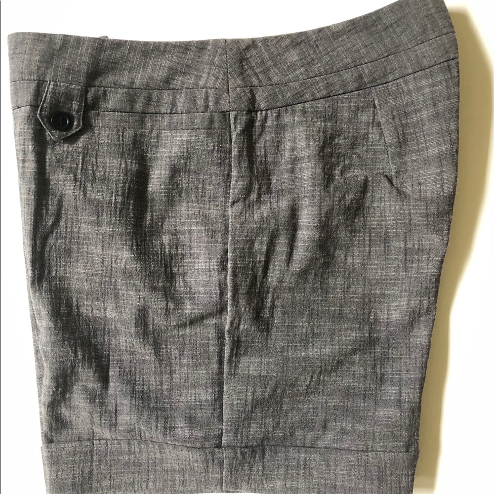 Dressy gray shorts with black buttons.